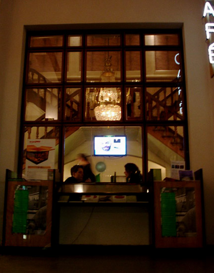 View into cafe with monitor showing Jeff and Katherine