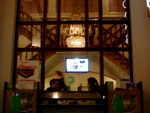 View into cafe with monitor showing Jeff and Katherine